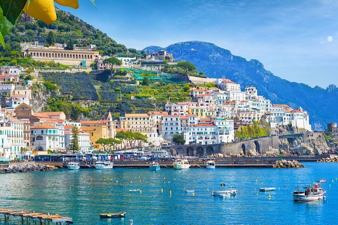 A town of the Amalfi Coast seen from the water, houses climbing the valley