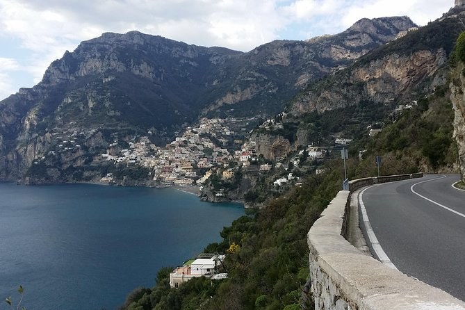 The coast road curving above the sea, Positano on the far slope