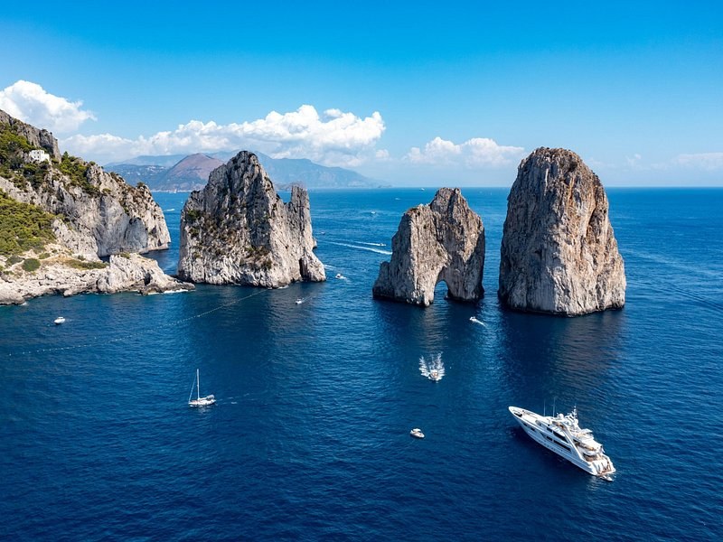The Faraglioni rocks off Capri from above, yachts at anchor nearby