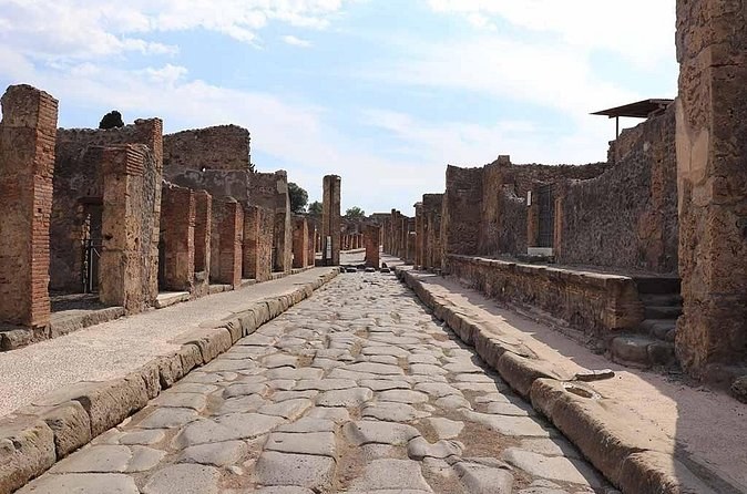 A paved Roman street between the walls of Pompeii