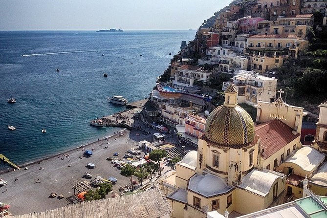 The dome of Santa Maria Assunta above Spiaggia Grande, boats at anchor in the bay