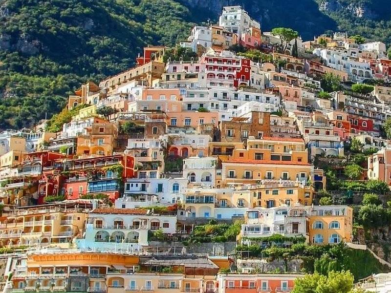 Pastel houses of Positano climbing the hillside above the beach