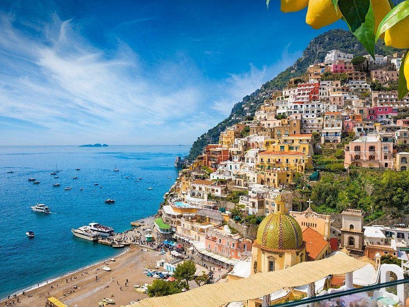 Positano's beach, its dome and the houses above, seen from the cliffs