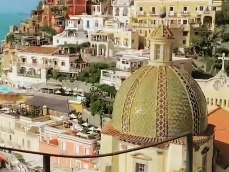 The green and yellow majolica tiles of the dome of Santa Maria Assunta