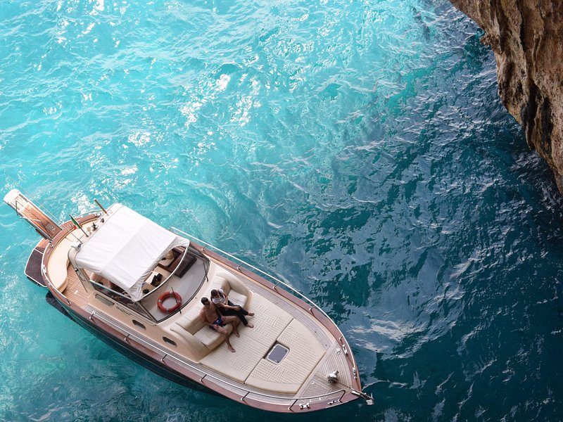 A wooden gozzo seen from above over clear water